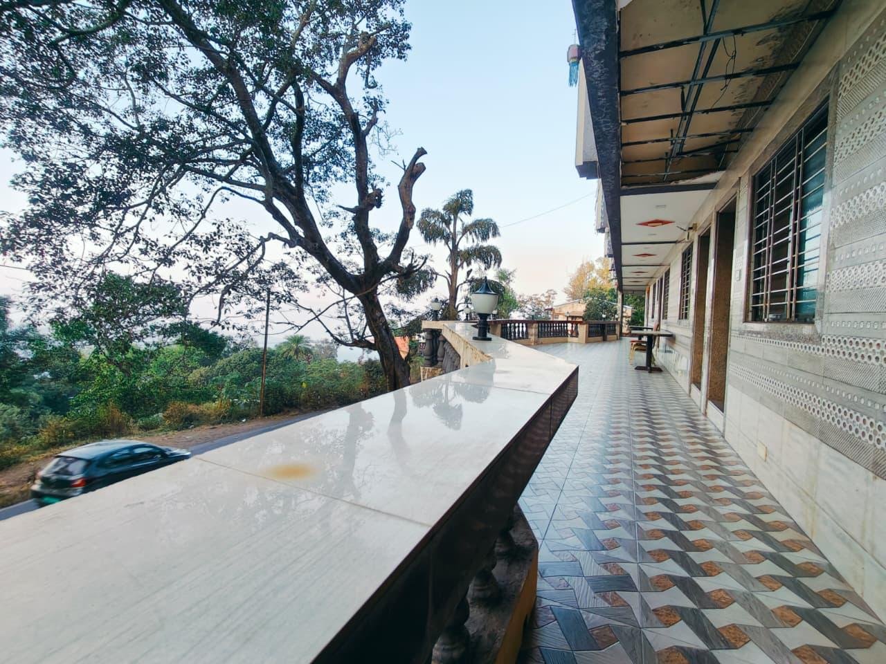 Long balcony corridor overlooking greenery